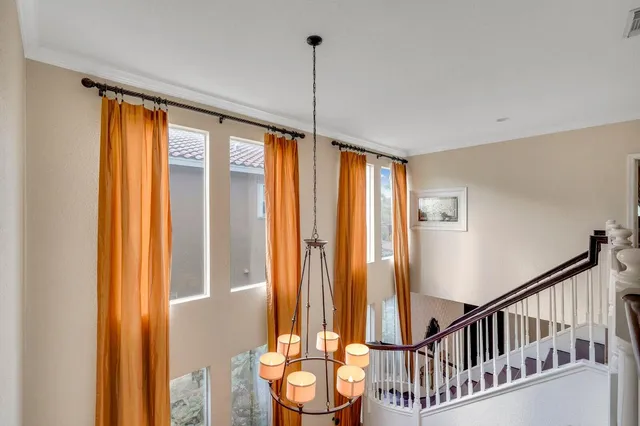 a spacious bedroom with a bed and a chandelier