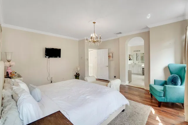 a large white bathroom with a double vanity sink a mirror and a bathtub