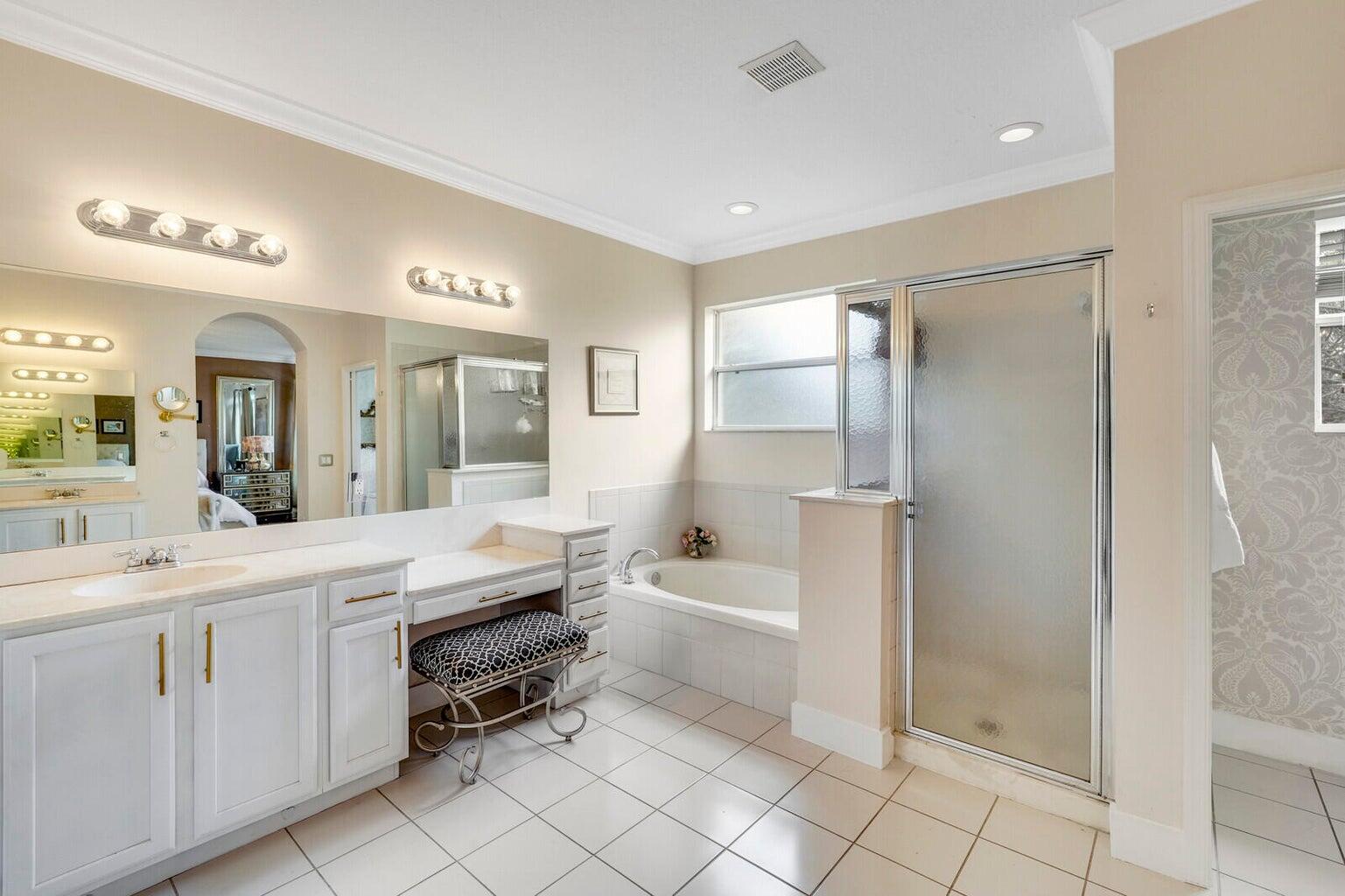 599 Cresta Circle West Palm Beach, FL 33413 - Photo 29 of 56 a large white bathroom with a double vanity sink a mirror and a bathtub
