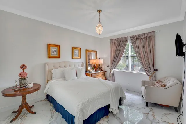 a bathroom with a toilet sink vanity tub and mirror