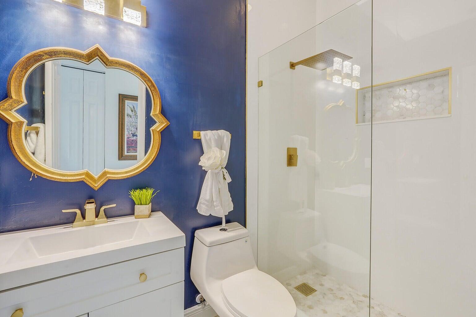 599 Cresta Circle West Palm Beach, FL 33413 - Photo 33 of 56 a bathroom with a toilet sink vanity tub and mirror