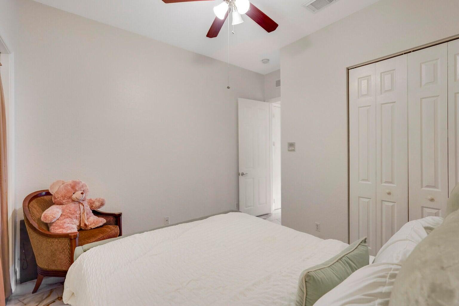 599 Cresta Circle West Palm Beach, FL 33413 - Photo 35 of 56 a bedroom with a bed and a chandelier fan