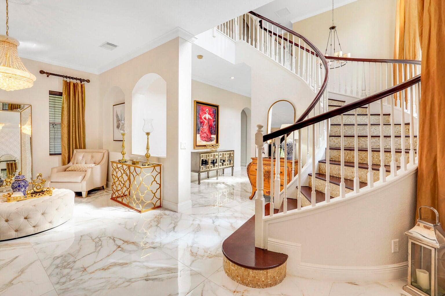 599 Cresta Circle West Palm Beach, FL 33413 - Photo 8 of 56 a view of staircase with lots of frames on wall and a large window