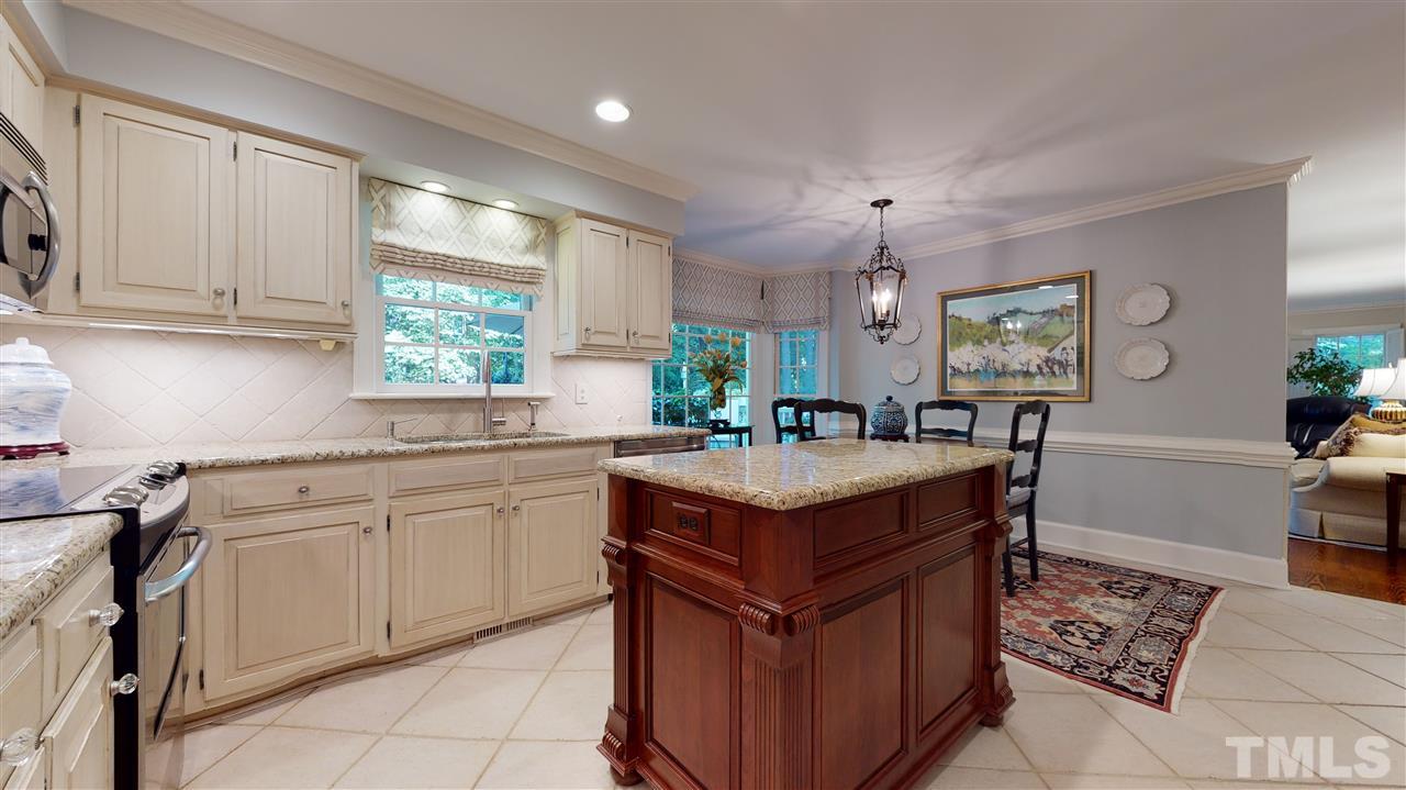 8817 Lomas Court Raleigh, NC 27615 - Photo 14 of 30 a kitchen with stainless steel appliances granite countertop a sink and a stove