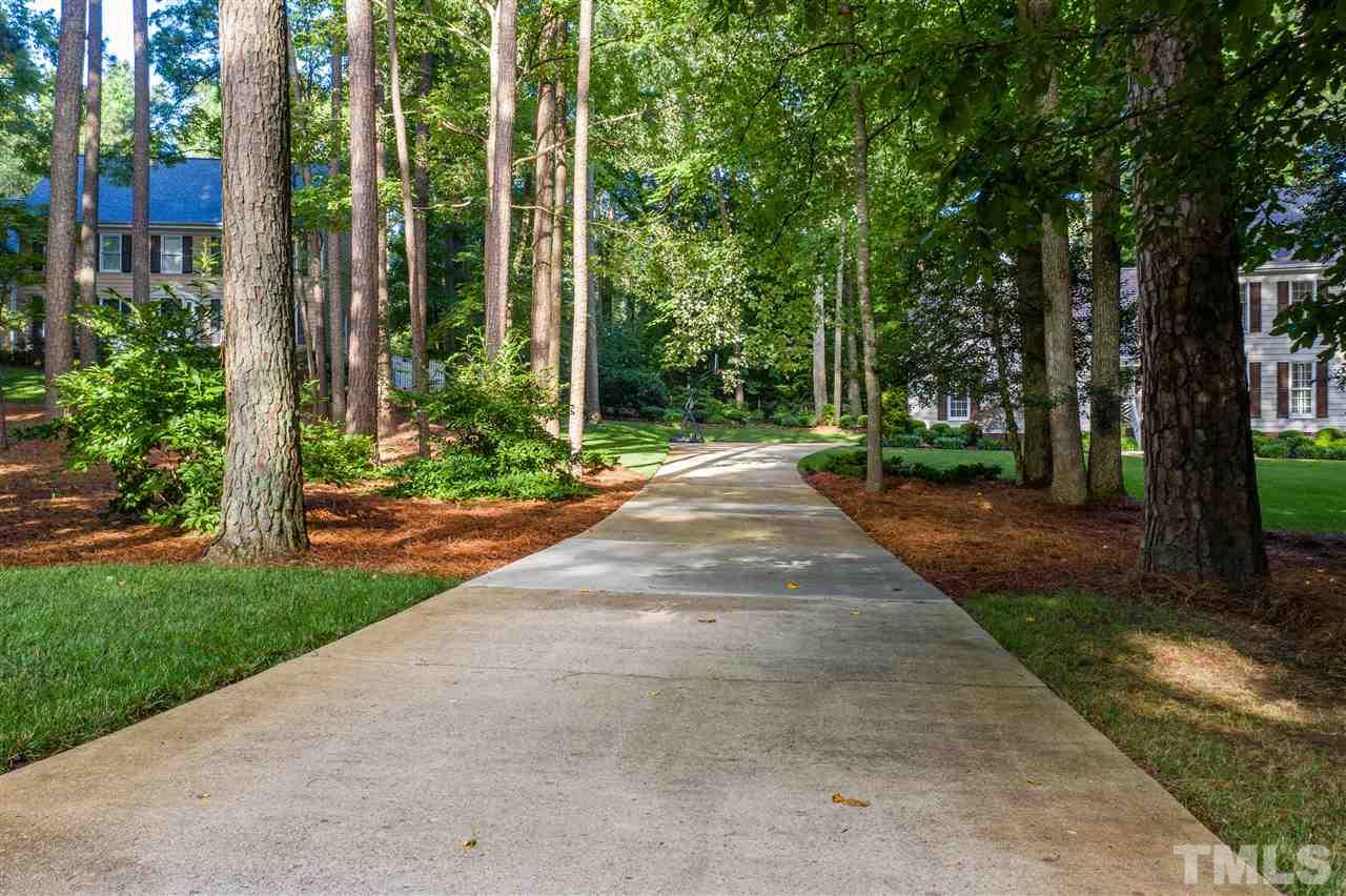 8817 Lomas Court Raleigh, NC 27615 - Photo 3 of 30 a view of a yard with plants and trees