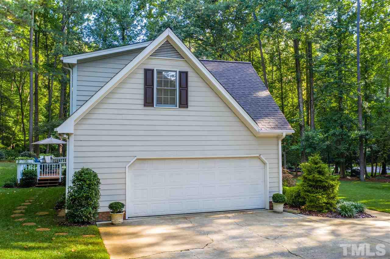 8817 Lomas Court Raleigh, NC 27615 - Photo 4 of 30 a front view of a house with a yard and garage