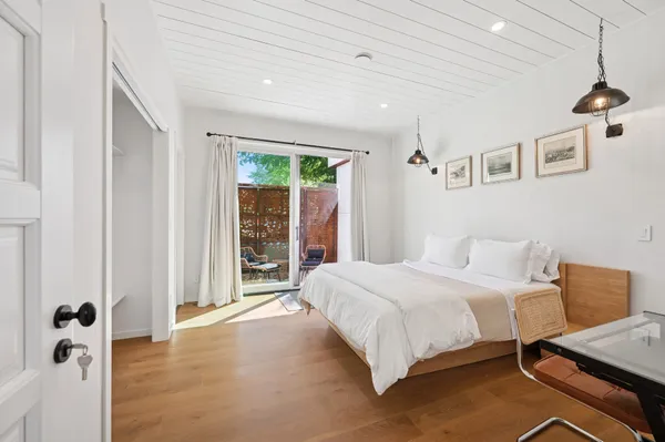 a bedroom with a large bed and a window