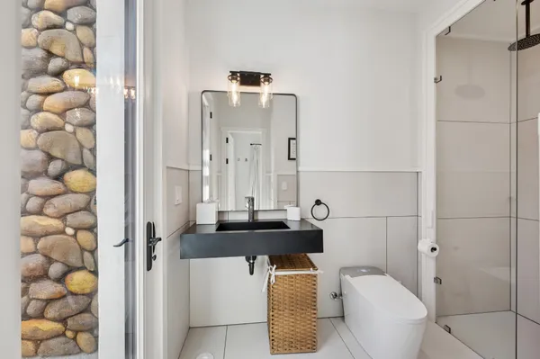 a bathroom with a sink toilet and shower