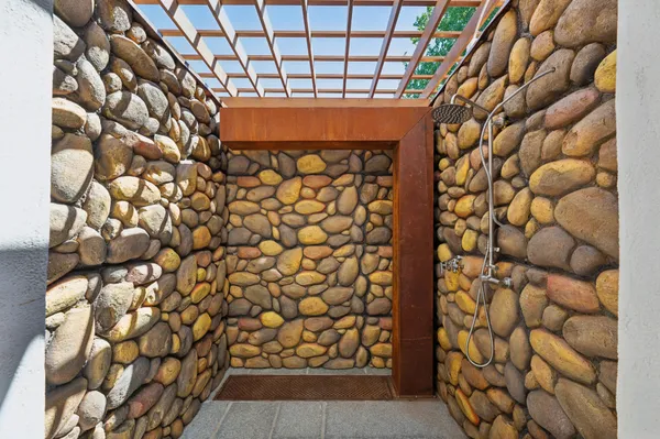 a room with a wooden wall and shower