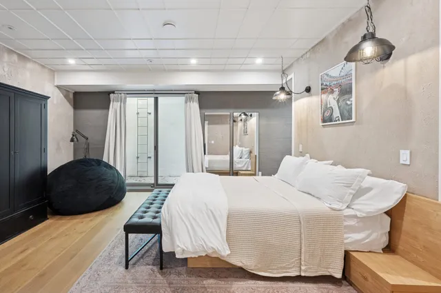 a bedroom with a bed and a chair