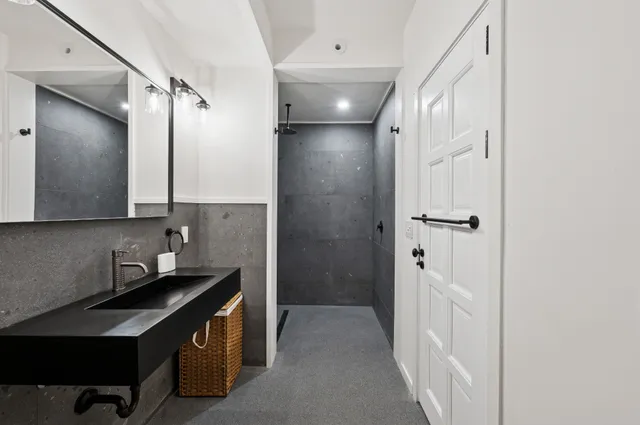 a bathroom with a double vanity sink a mirror and shower