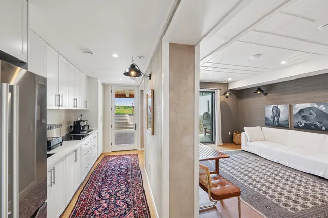 a hallway with a dining table and chairs