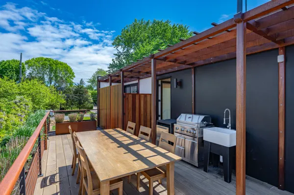 a backyard of a house with table and chairs