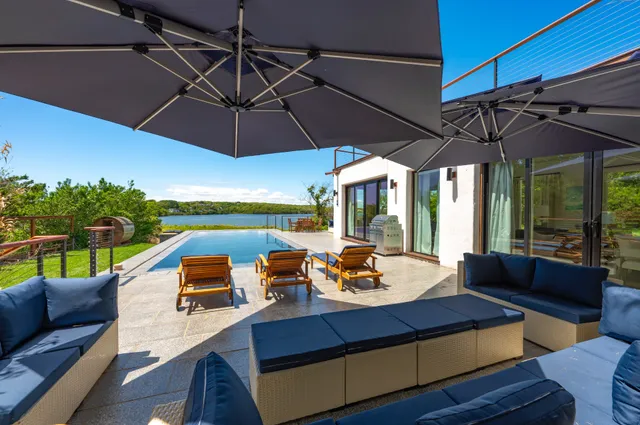 a view of a patio with a table chairs and a umbrella