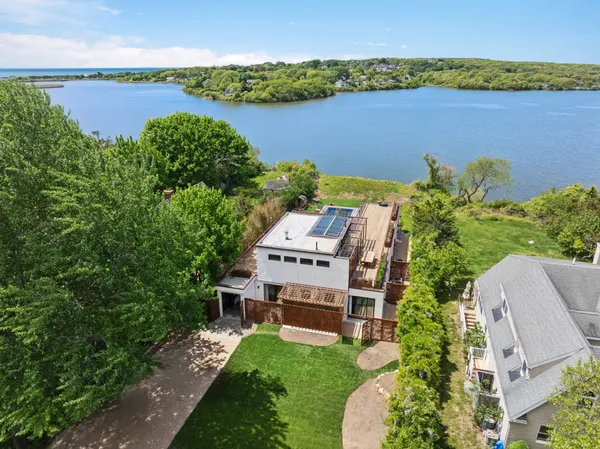 an aerial view of a house with a lake view