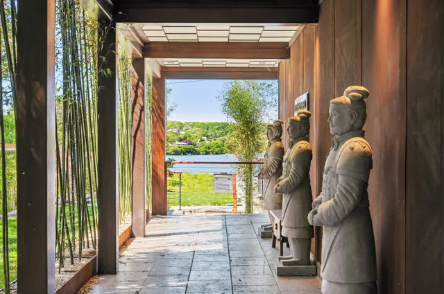 an outdoor sitting area with furniture and umbrella