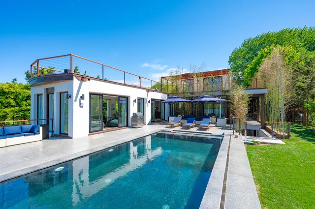 a view of a patio with swimming pool table and chairs
