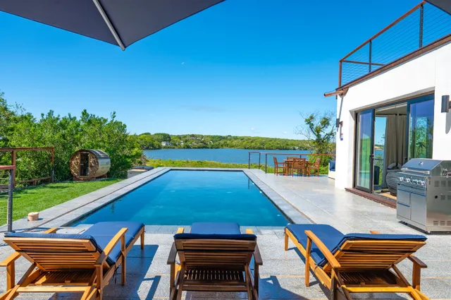 a view of a terrace with couches and ocean view