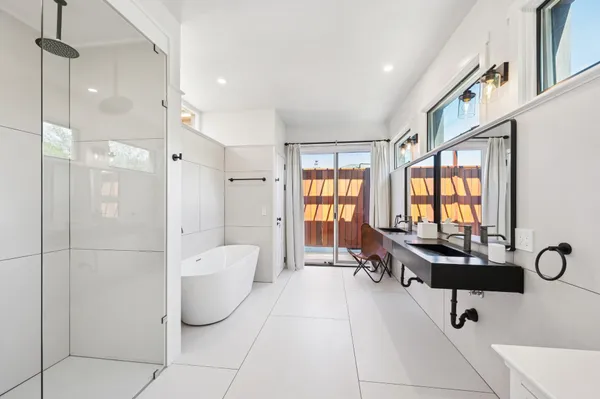 a spacious bathroom with a tub and shower