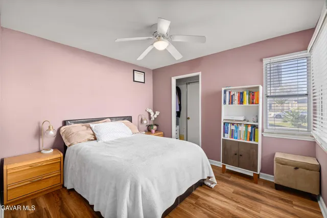 a spacious bedroom with a bed and a chandelier