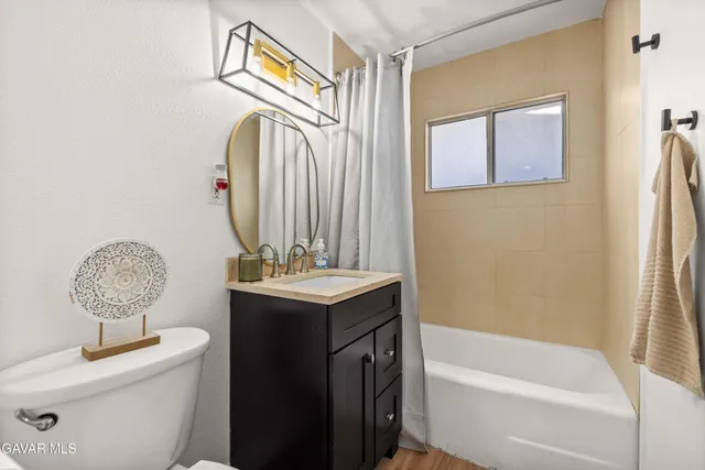 a bathroom with a bath tub sink and mirror