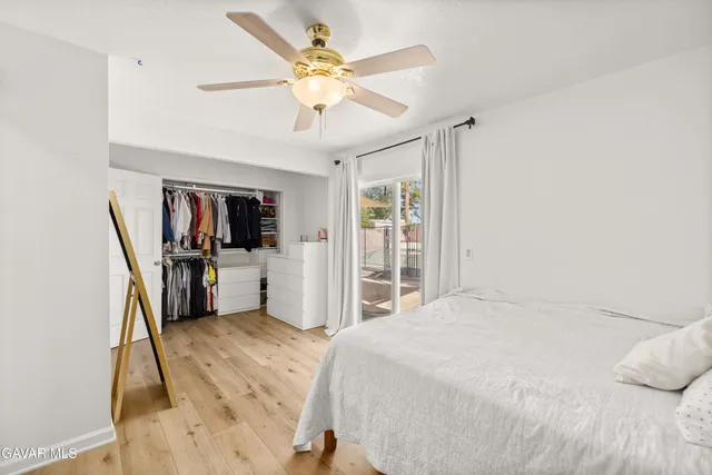 a bedroom with a bed a window and gym equipment