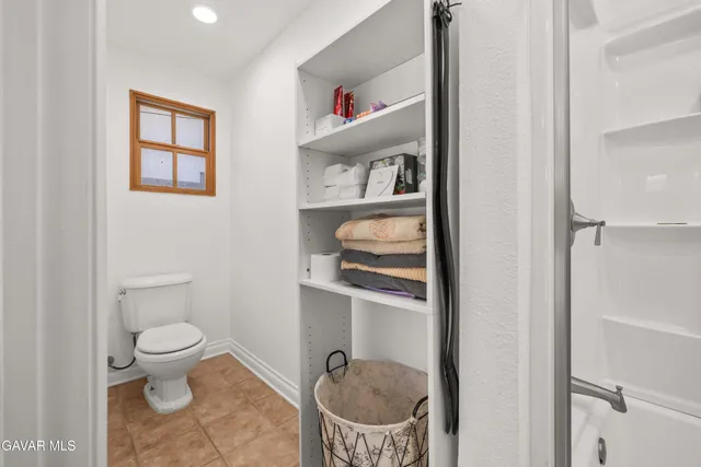 a bathroom with a toilet a sink and a shower