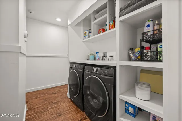 a utility room with sink dryer and washer