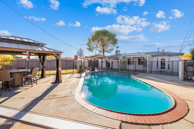 an outdoor space with pool and furniture