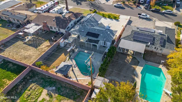 an aerial view of a house with a garden and swimming pool