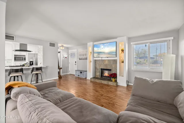a living room with furniture and a fireplace