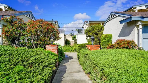 a view of a house with potted plants
