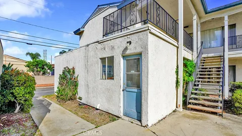 a view of a house with potted plants