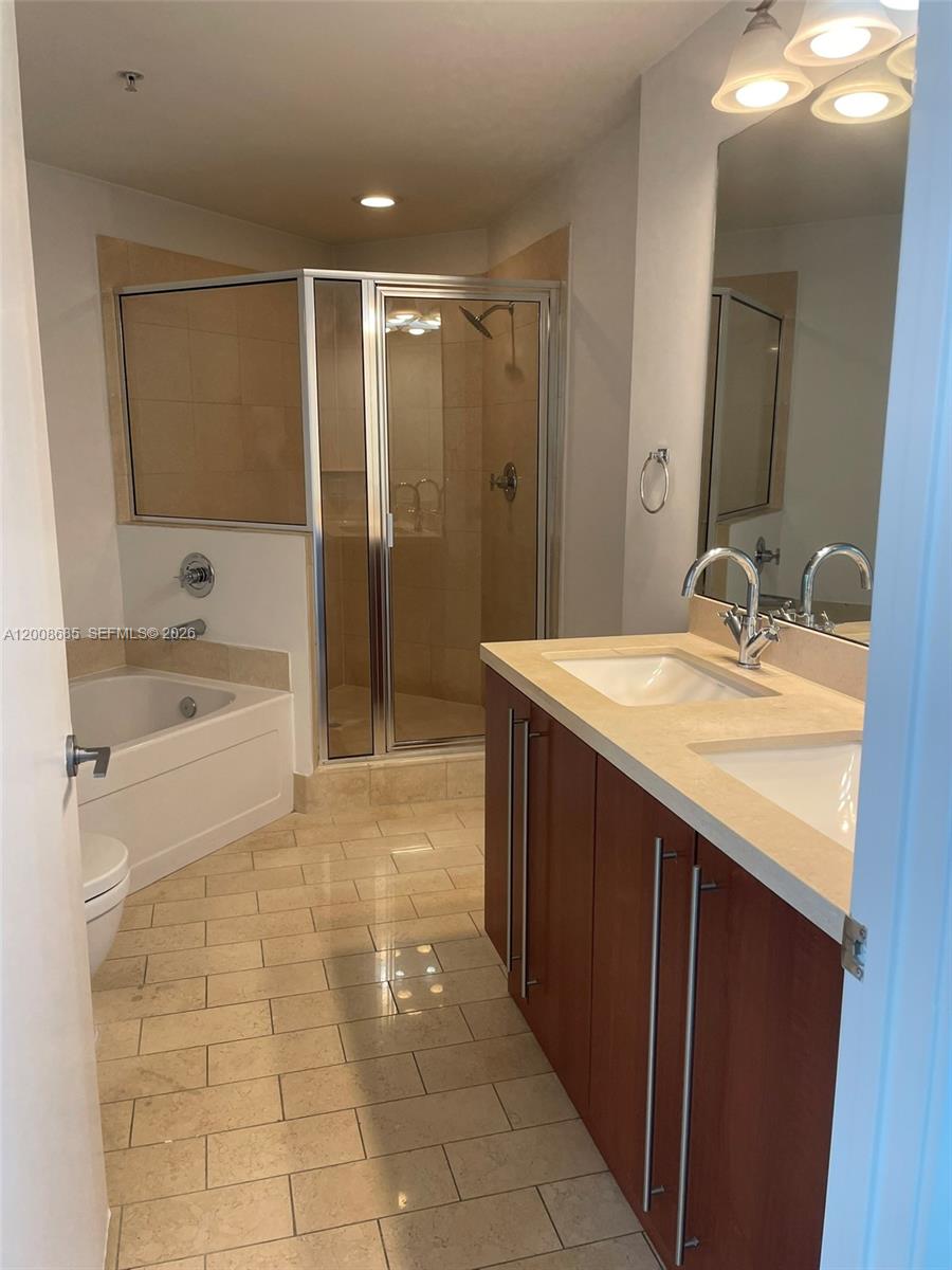 79 Southwest 12th Street, Unit 1601S Miami, FL 33130 - Photo 11 of 18 a bathroom with a sink a toilet and shower
