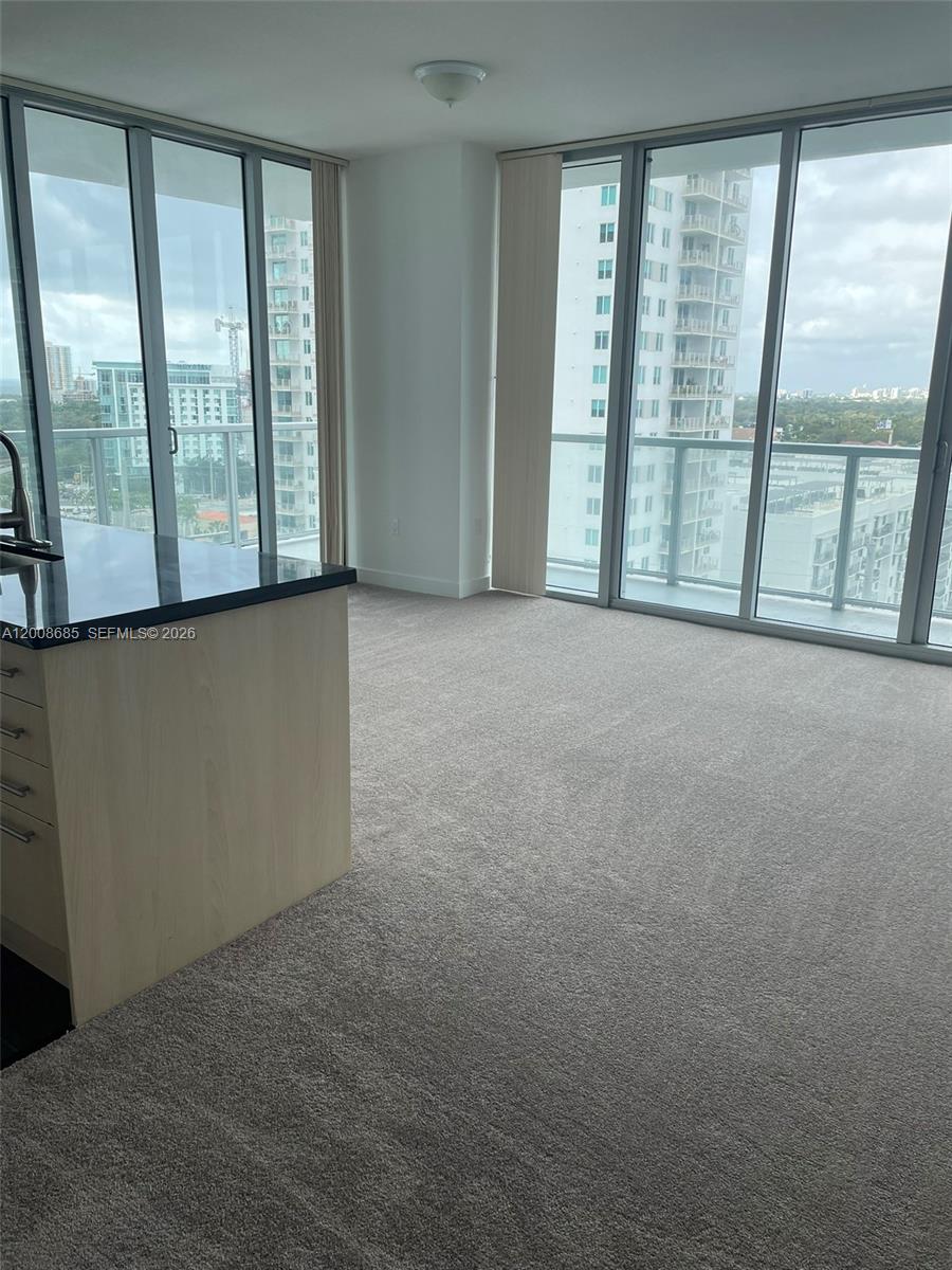 79 Southwest 12th Street, Unit 1601S Miami, FL 33130 - Photo 5 of 18 a view of an empty room with windows and city view