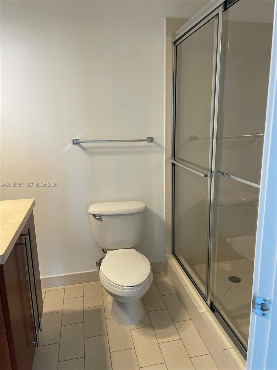 79 Southwest 12th Street, Unit 1601S Miami, FL 33130 - Photo 6 of 18 a white toilet sitting next to a bathroom sink
