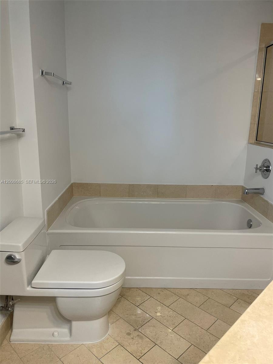 79 Southwest 12th Street, Unit 1601S Miami, FL 33130 - Photo 10 of 18 a bathroom with a toilet and a bathtub
