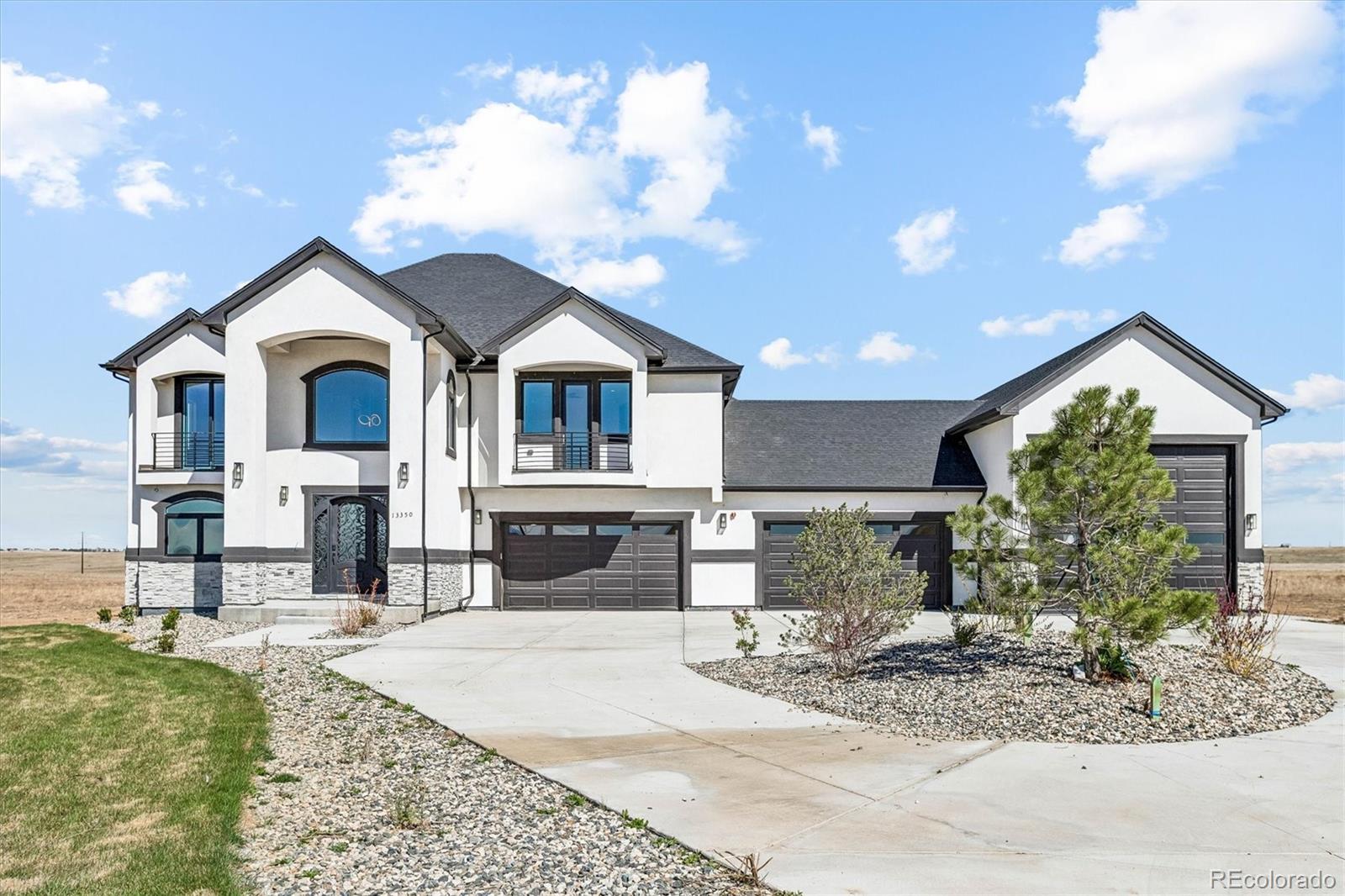 13350 Imboden Road Hudson, CO 80642 - Photo 1 of 50 a front view of a house with a yard and garage