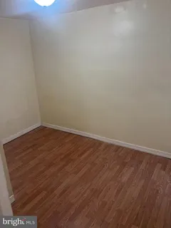 an empty room with wooden floor