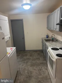 a kitchen with a stove top oven and sink