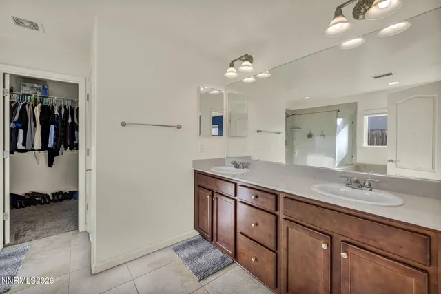 a spacious bathroom with a double vanity sink and a mirror