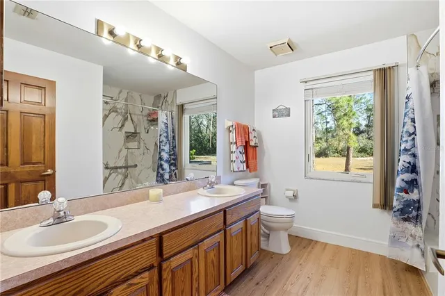 a view of a livingroom with furniture a ceiling fan and a fireplace