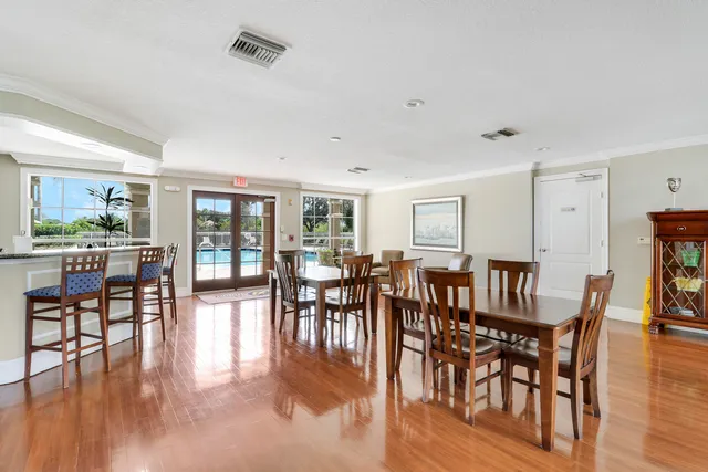 a view of a dining room and livingroom with lots of furniture and wooden floor