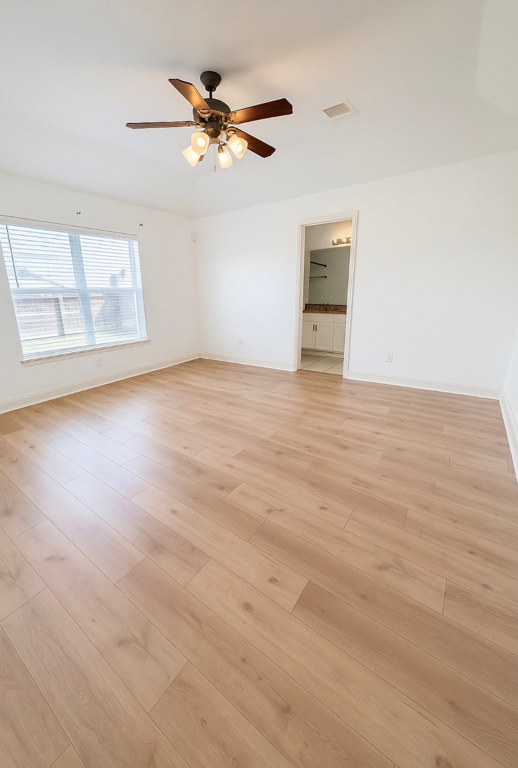 4915 Manor Stone Lane Rosenberg, TX 77469 - Photo 6 of 10 an empty room with wooden floor and windows