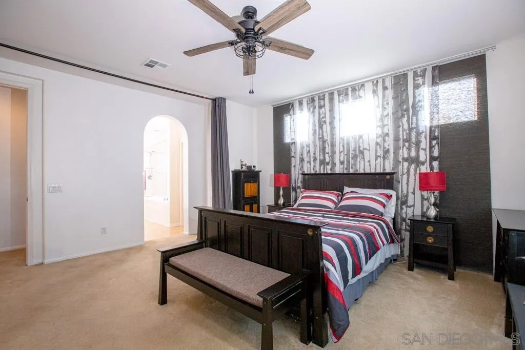 31340 Locust Court Temecula, CA 92592 - Photo 13 of 24 a bedroom with a bed and a chandelier
