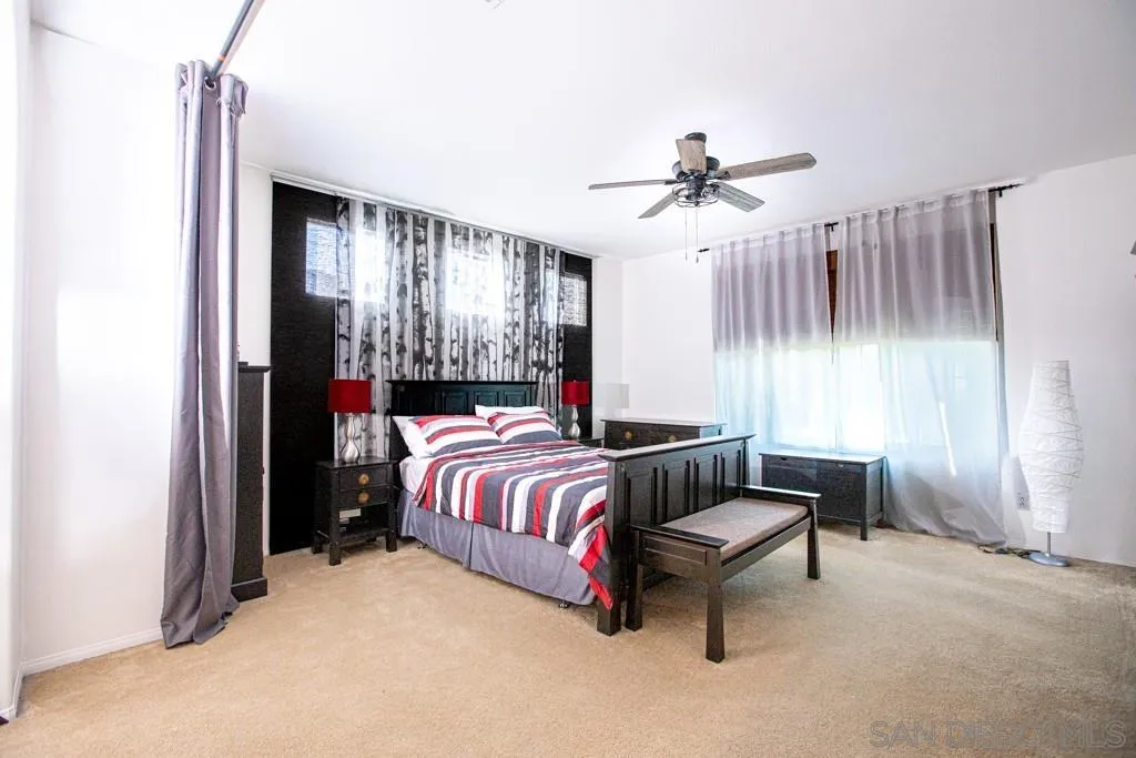 31340 Locust Court Temecula, CA 92592 - Photo 14 of 24 a bedroom with a bed and a chandelier