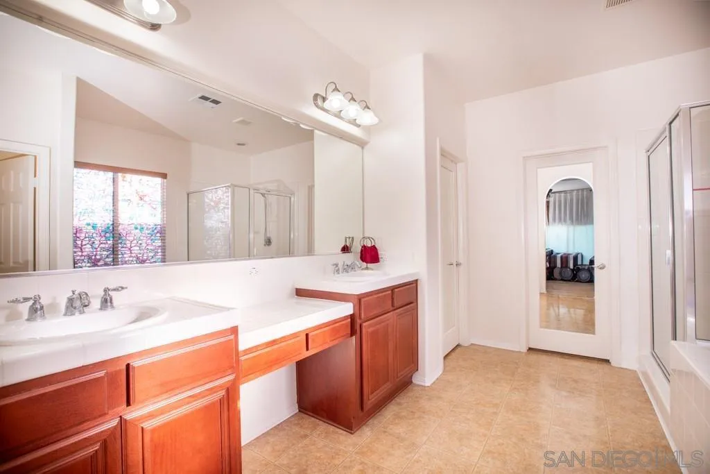 31340 Locust Court Temecula, CA 92592 - Photo 15 of 24 a spacious bathroom with a sink double vanity and a mirror