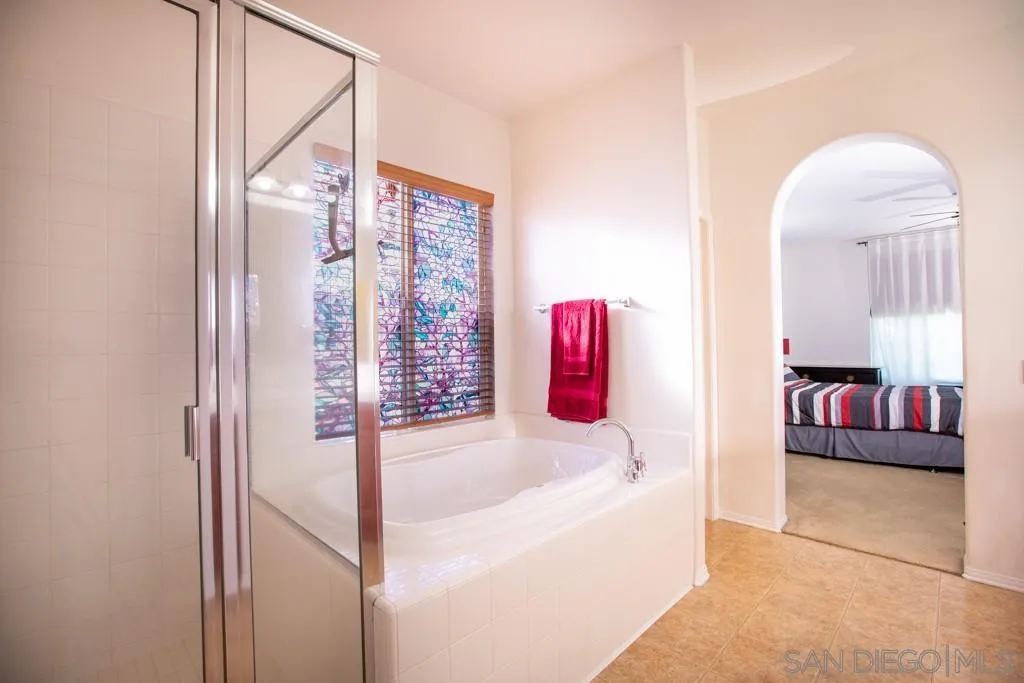 31340 Locust Court Temecula, CA 92592 - Photo 16 of 24 a bathroom with a tub and shower