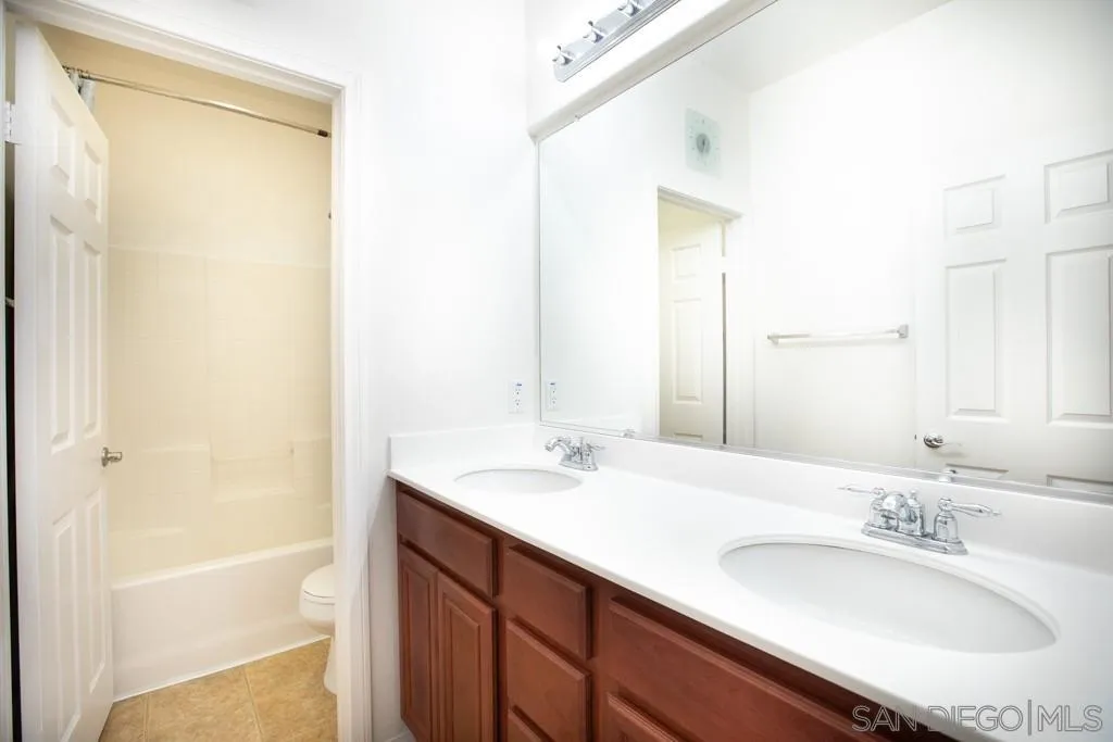 31340 Locust Court Temecula, CA 92592 - Photo 17 of 24 a bathroom with a granite countertop sink and a mirror