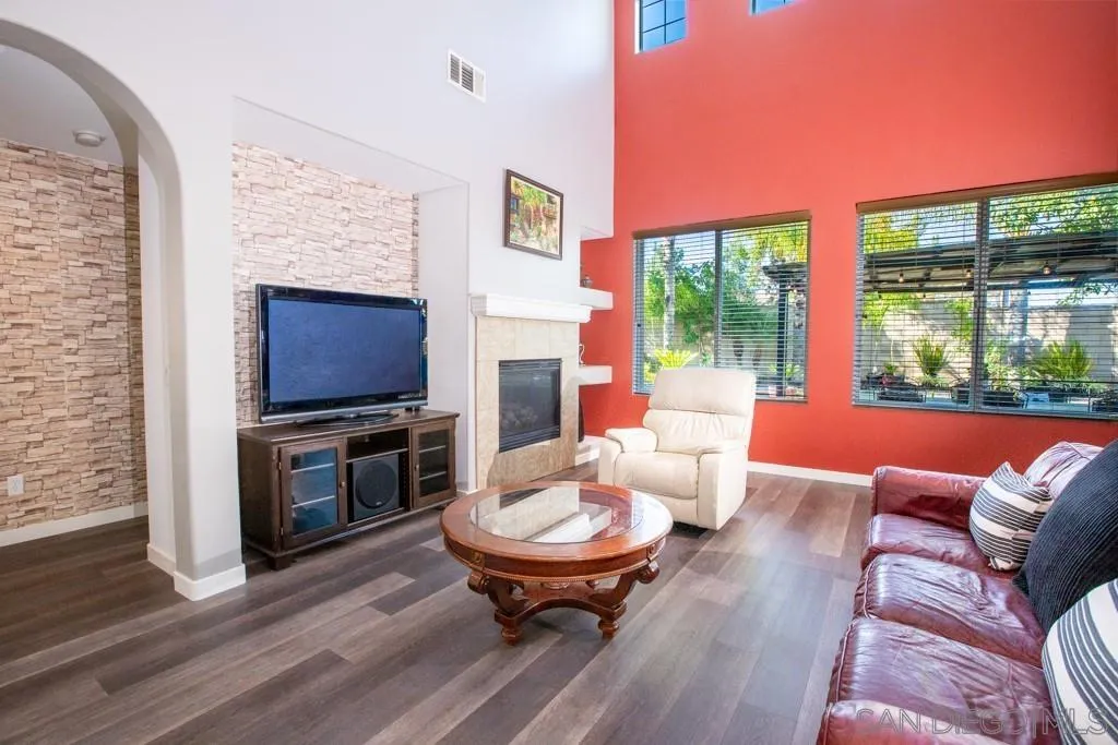 31340 Locust Court Temecula, CA 92592 - Photo 6 of 24 a living room with furniture a flat screen tv and a fireplace